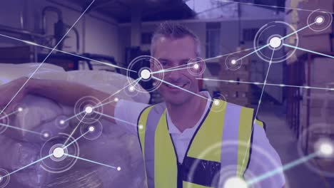 Animation-of-network-of-connections-over-caucasian-man-working-in-warehouse