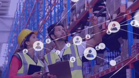 Animation-of-network-of-connections-with-icons-over-diverse-workers-at-warehouse