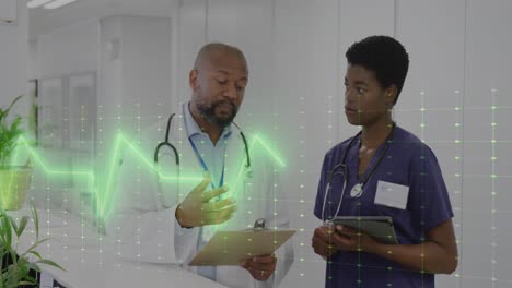 Animation-of-vital-signs-monitor-over-african-american-female-and-male-doctor-talking-in-hospital