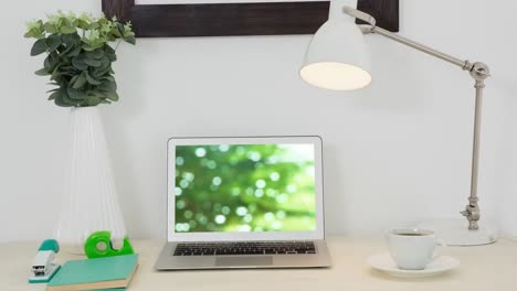 Animation-of-green-water-on-laptop-screen-on-desk
