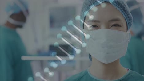 Animation-Eines-DNA-Strangs-über-Dem-Porträt-Einer-Lächelnden-Asiatischen-Chirurgin-Im-Operationssaal