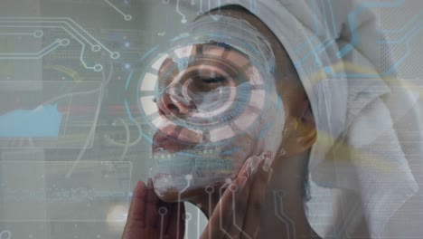 Animation-of-round-scanner-and-data-processing-over-biracial-woman-applying-face-mask-at-home