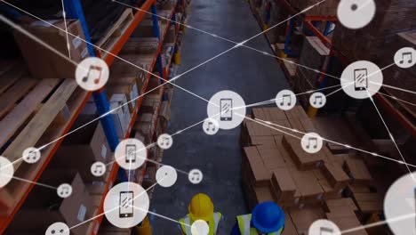 Animation-of-network-of-digital-icons-over-aerial-view-of-workers-working-at-warehouse