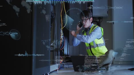 Animation-of-data-processing-over-asian-male-engineer-talking-on-smartphone-at-computer-server-room