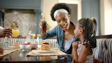 Happy-african-american-family-having-breakfast,-in-slow-motion