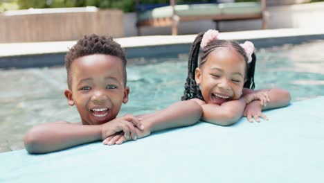 Portrait-of-happy-african-american-siblings-at-pool,-in-slow-motion