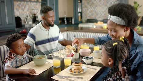 Happy-african-american-family-having-breakfast,-in-slow-motion