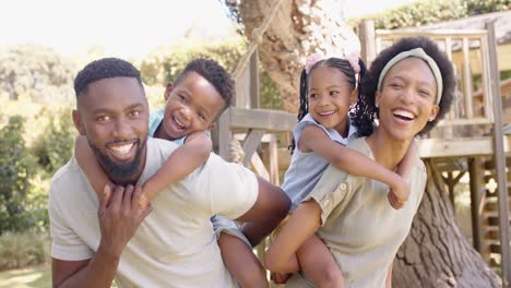 Portrait-of-happy-african-american-family-in-garden,-in-slow-motion