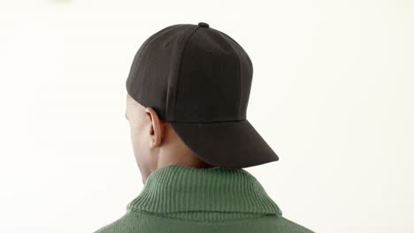 African-american-man-wearing-black-peaked-cap-with-copy-space-on-white-background