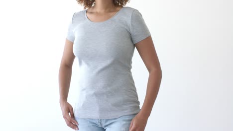 Midsection-of-african-american-woman-wearing-grey-t-shirt-with-copy-space-on-white-background