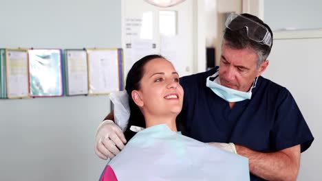 Dentist-speaking-with-his-patient-
