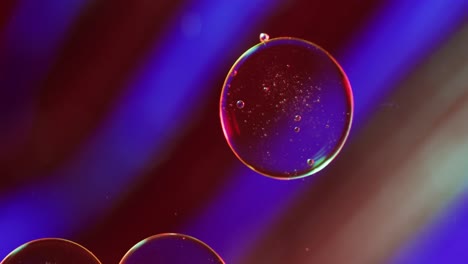 Animation-of-bubbles-moving-on-red-and-blue-background-with-copy-space