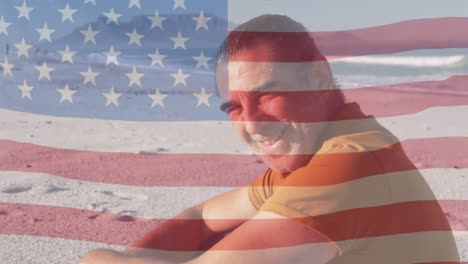 Animation-of-flag-of-usa-over-smiling-caucasian-man-on-beach