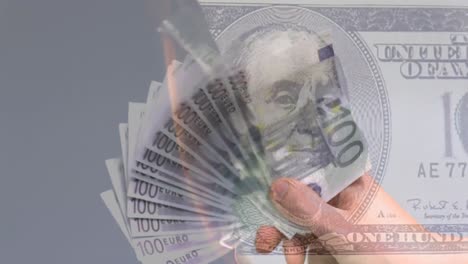 Animation-of-burning-american-dollar-banknote-over-hand-waving-euro-banknotes