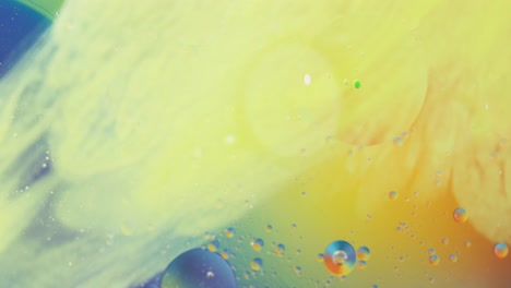 Animation-of-bubbles-moving-on-blue-and-yellow-background-with-copy-space