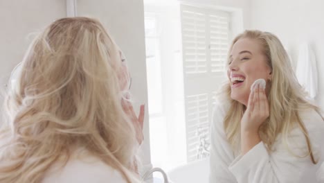 Happy-caucasian-plus-size-woman-in-front-of-mirror-doing-make-up-in-slow-motion