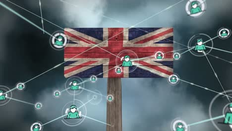 Animation-of-network-of-connections-with-icons-and-clouds-over-flag-of-uk