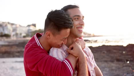 Happy-diverse-gay-male-couple-embracing-at-beach,-slow-motion