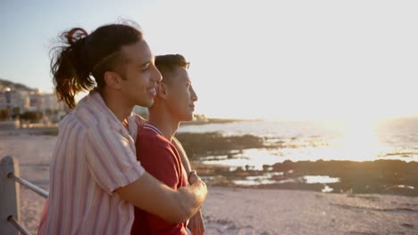 Happy-diverse-gay-male-couple-embracing-at-promenade-by-the-sea,-slow-motion