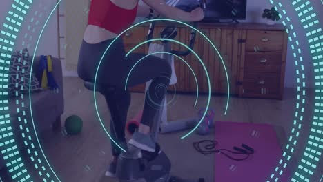 Animation-of-data-processing-over-caucasian-woman-exercising,-using-stationary-bike