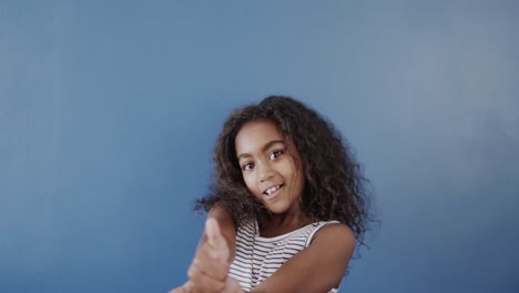 Happy-african-american-girl-using-sign-language-on-blue-background,-slow-motion