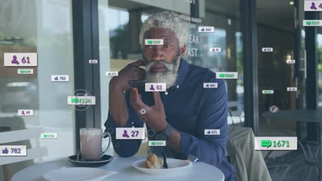 Animation-of-social-media-icons-and-numbers-over-african-american-man-using-smartphone