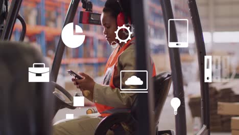 Animation-of-media-icons-over-african-american-female-worker-using-smartphone-in-warehouse
