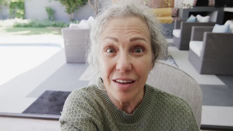 Happy-senior-caucasian-woman-making-video-call-in-garden,-slow-motion