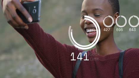 Animation-of-happy-african-american-woman-taking-selfie-over-loading-circles