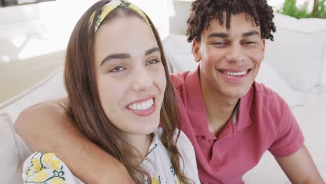 Portrait-of-happy-biracial-couple-spending-time-at-home-and-having-video-call