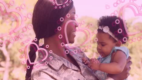 Animation-of-heart-icons-over-happy-african-american-female-soldier-with-daughter