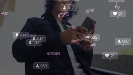 Animation-of-changing-numbers-and-social-media-icons-over-biracial-man-using-smartphone