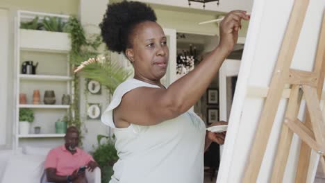 Happy-senior-african-american-woman-painting-in-slow-motion