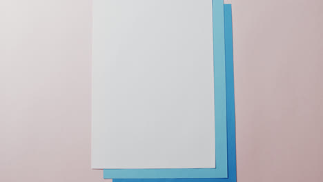 Close-up-of-blank-card-on-white-background-with-copy-space-in-slow-motion