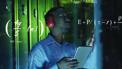 Animation-of-equations-over-african-american-male-engineer-using-digital-tablet-at-server-room