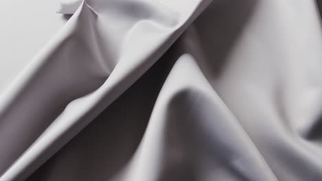Close-up-of-gray-shiny-silk-cloth-in-slow-motion