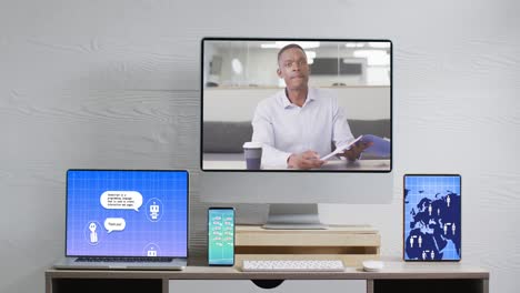 Composition-of-african-american-man-on-computer-screen,-electronic-devices-with-ai-chat-on-screens