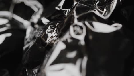 Close-up-of-black-crumpled-plastic-rubbish-bag-in-slow-motion