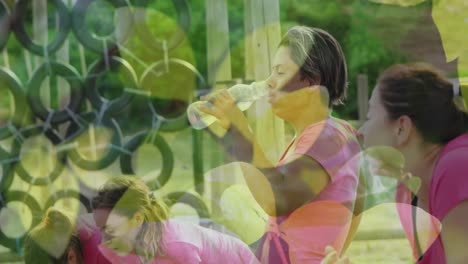 Animation-of-leaves-over-diverse-women-at-obstacle-course-drinking-water