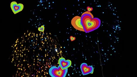 Animation-of-rainbow-hearts-over-fireworks-on-black-background