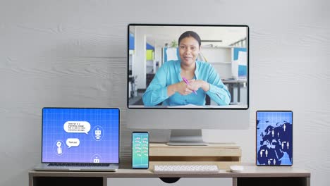 Composition-of-biracial-woman-on-computer-screen,-electronic-devices-with-ai-chat-on-screens