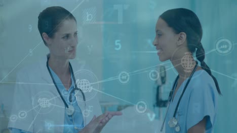 Animation-of-connected-icons,-texts,-letters,-symbols,-diverse-female-doctors-having-conversation