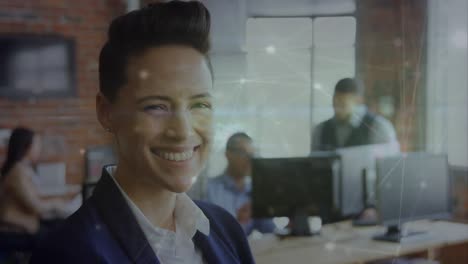Animation-of-glowing-network-of-connections-against-caucasian-businesswoman-smiling-at-office