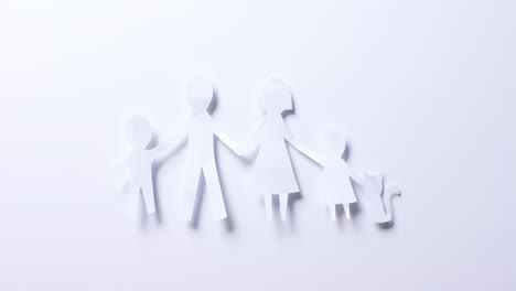 Close-up-of-family-with-cat-made-of-white-paper-on-white-background-with-copy-space