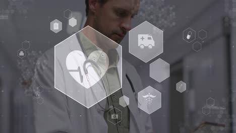Animation-Medizinischer-Symbole-über-Einem-Kaukasischen-Männlichen-Arzt,-Der-Im-Krankenhaus-Ein-Digitales-Tablet-Verwendet