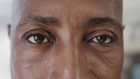Close-up-of-african-american-male-doctor-looking-at-camera,-slow-motion