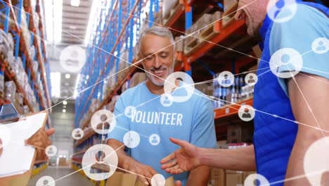 Animation-of-network-of-connections-over-diverse-volunteers-shaking-hands-in-warehouse