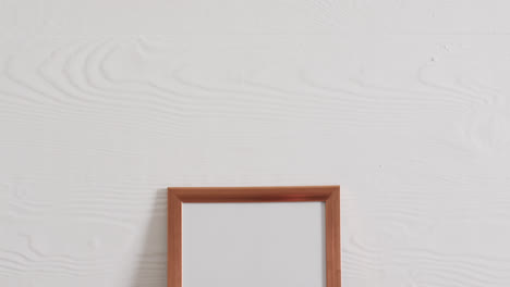 Wooden-frame-with-copy-space-on-white-background-and-white-wall