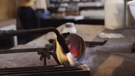 Close-up-of-melting-metal-with-blowtorch-in-workshop-in-slow-motion