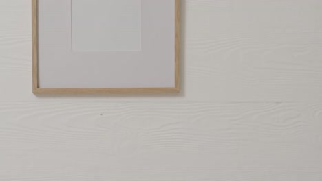 Wooden-frame-with-copy-space-with-white-background-and-white-wall